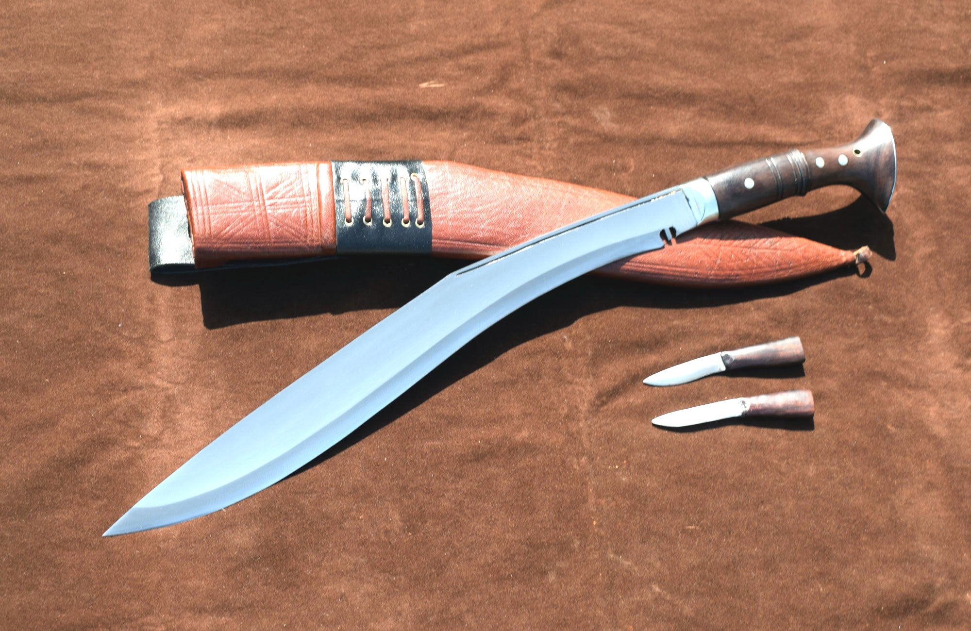 Sirupate Kukri knife angled view showing full tang blade, rosewood handle, brown sheath, and karda knives – Grace Kukri House