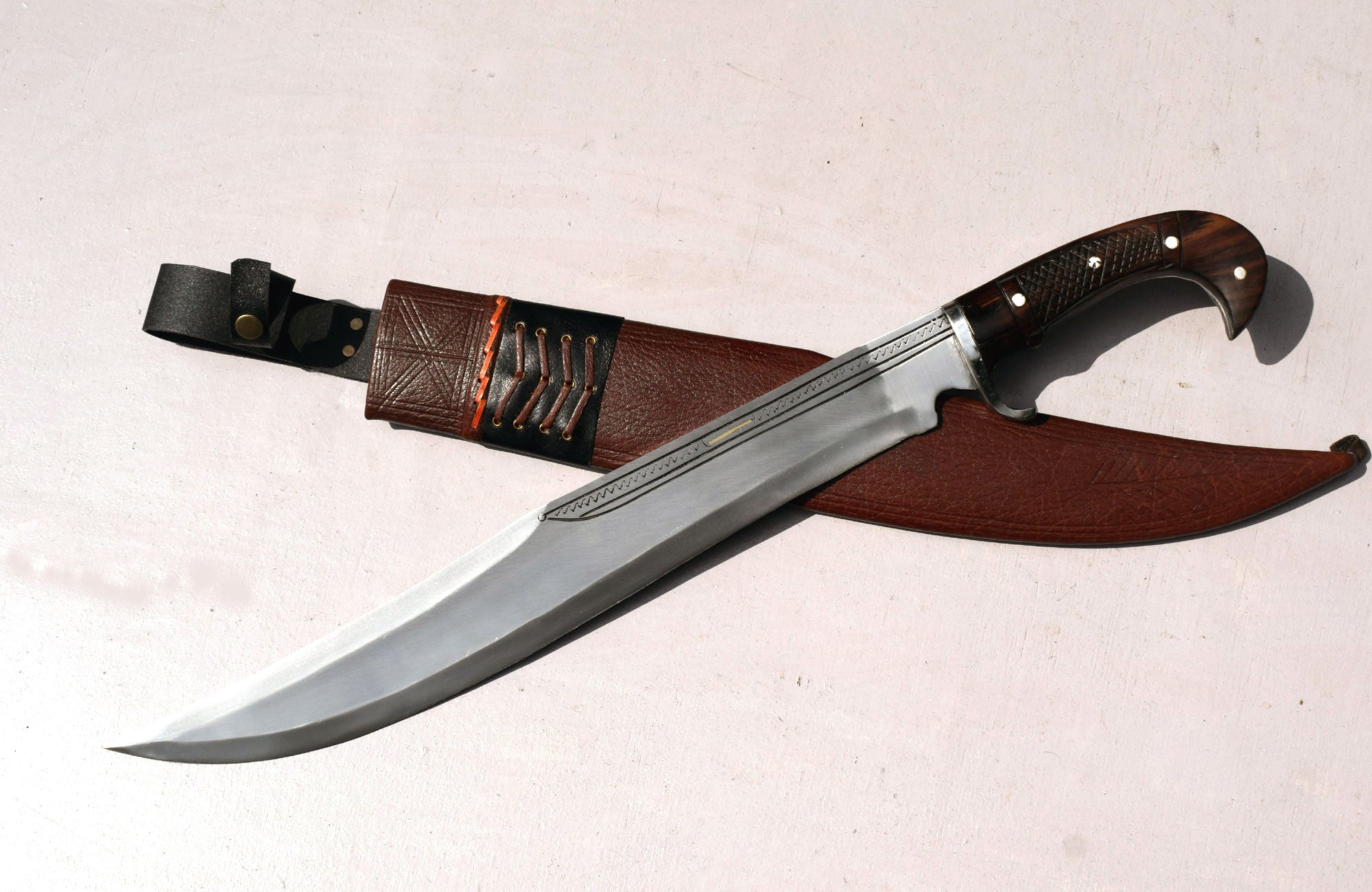 Kukri kopis machete with brown sheath and red lacing detail – cottonwood core scabbard